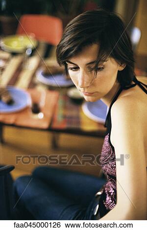 Stock Photograph - Woman looking away from set table. Fotosearch