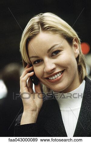 Woman phoning using cell phone smiling at camera, portrait View Large Photo Image Stock Photo - Woman phoning using cell phone smiling at camera, portrait. Fotosearch