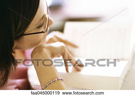 Stock Photo - Woman reading book, close-up. Fotosearch