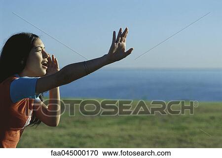 Stock Image - Woman shouting, beckoning. Fotosearch