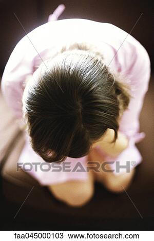 Stock Image - Woman sitting, high angle view. Fotosearch