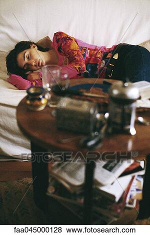 Woman sleeping on sofa lying on side View Large Photo Image Stock Photo - Woman sleeping on sofa lying on side. Fotosearch