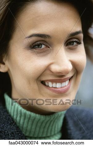 Woman smiling at camera with amusement, portrait View Large Photo Image Picture - Woman smiling at camera with amusement, portrait. Fotosearch