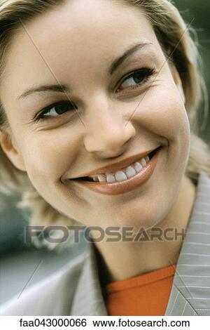 Woman smiling glancing sideways, portrait View Large Photo Image Stock Photograph - Woman smiling glancing sideways, portrait. Fotosearch