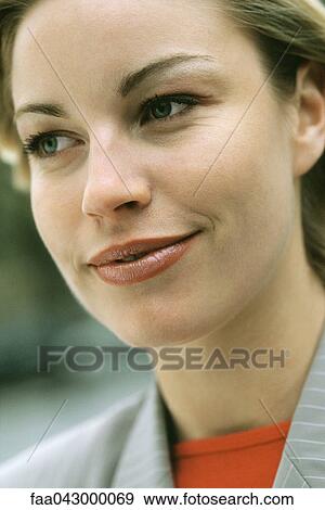 Woman smiling, looking away, portrait View Large Photo Image Stock Photo - Woman smiling, looking away, portrait. Fotosearch