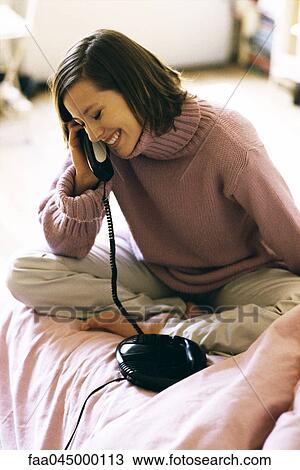 Woman using phone, laughing View Large Photo Image Stock Image - Woman using phone, laughing. Fotosearch