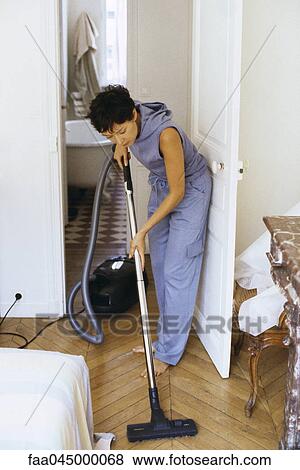 Woman vacuuming View Large Photo Image Stock Photo - Woman vacuuming. Fotosearch