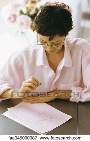 Woman writing and reviewing correspondence View Large Photo Image Stock Photo - Woman writing and reviewing correspondence. Fotosearch