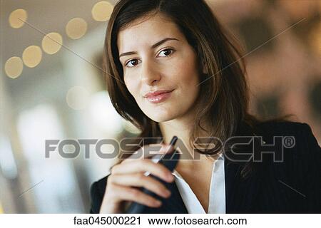 Young businesswoman smiling at camera, portrait View Large Photo Image Stock Image - Young businesswoman smiling at camera, portrait. Fotosearch