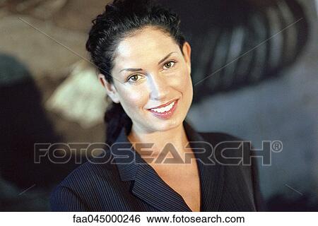 Young businesswoman smiling, portrait View Large Photo Image Stock Photograph - Young businesswoman smiling, portrait. Fotosearch