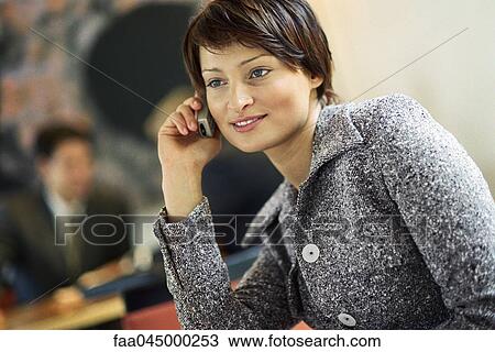 Young businesswoman using cell phone, smiling View Large Photo Image Stock Image - Young businesswoman using cell phone, smiling. Fotosearch