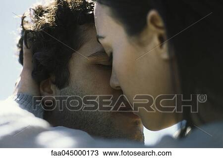 Young couple kissing, close-up View Large Photo Image Stock Image - Young couple kissing, close-up. Fotosearch