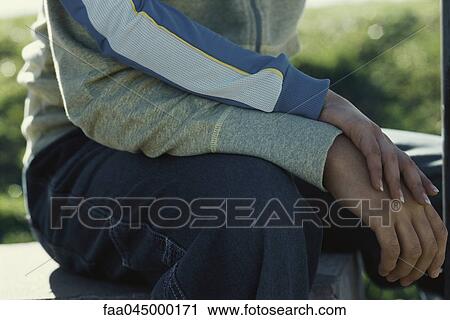 Stock Image - Young couple touching hands. Fotosearch