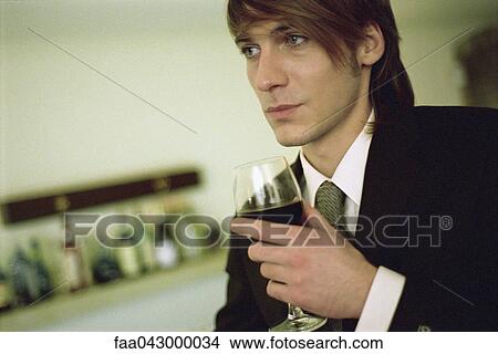 Young man with glass of wine View Large Photo Image Picture - Young man with glass of wine. Fotosearch