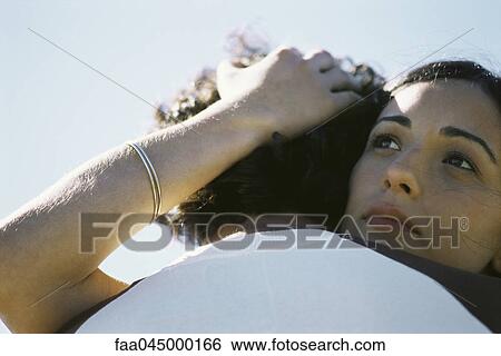 Young woman embracing man, looking away View Large Photo Image Stock Photograph - Young woman embracing man, looking away. Fotosearch