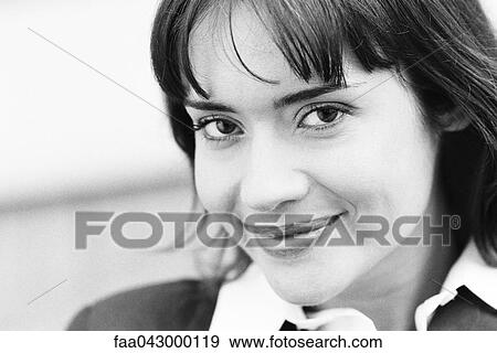 Young woman smiling at camera, portrait View Large Photo Image Stock Photo - Young woman smiling at camera, portrait. Fotosearch