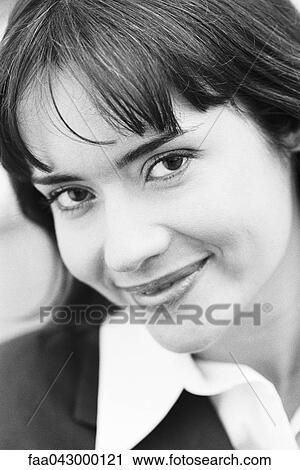 Young woman smiling coyly at camera, portrait View Large Photo Image Stock Image - Young woman smiling coyly at camera, portrait. Fotosearch