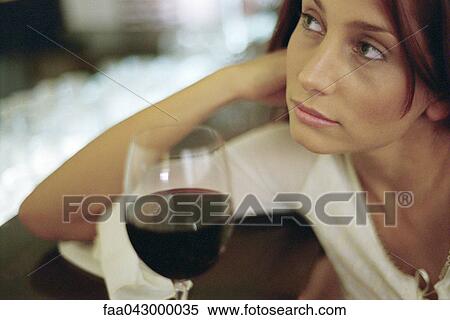 Young woman with glass of wine, leaning on elbow, looking away View Large Photo Image Stock Photography - Young woman with glass of wine, leaning on elbow, looking away. Fotosearch