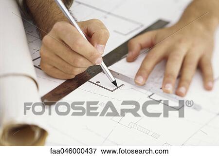Stock Photo - Architect editing blueprint, close-up. Fotosearch