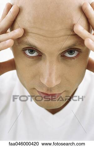 Bald man holding head, looking at camera View Large Photo Image Stock Image - Bald man holding head, looking at camera. Fotosearch