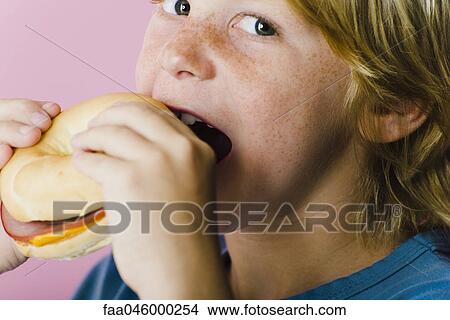 Boy eating ham and cheese sandwich View Large Photo Image Picture - Boy eating ham and cheese sandwich. Fotosearch