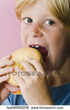 Boy eating ham and cheese sandwich View Large Photo Image Stock Photograph - Boy eating ham and cheese sandwich. Fotosearch