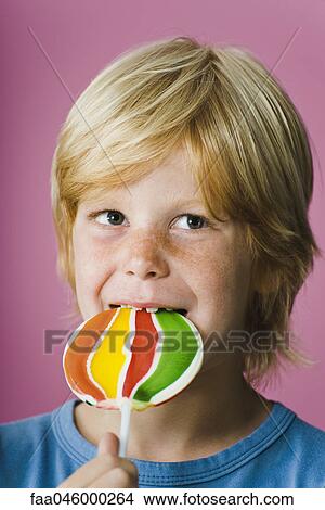Boy eating lollipop View Large Photo Image Picture - Boy eating lollipop. Fotosearch
