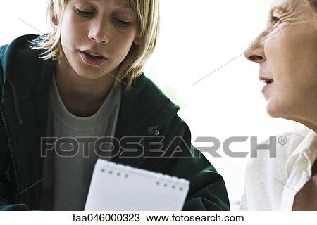 Stock Image - Boy talking with grandmother. Fotosearch