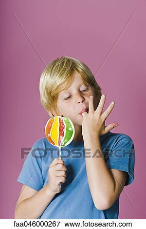 Boy with lollipop, licking fingers View Large Photo Image Stock Photo - Boy with lollipop, licking fingers. Fotosearch