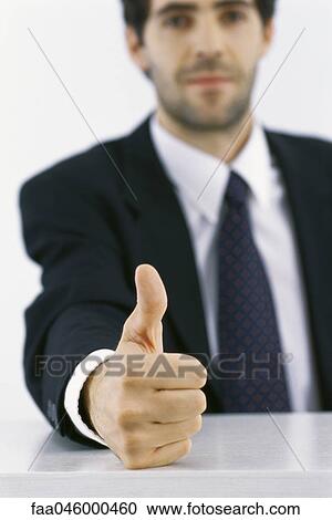 Stock Image - Businessman giving thumbs up. Fotosearch