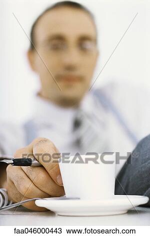 Stock Image - Businessman on coffee break. Fotosearch