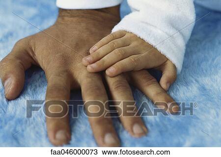 Child's hand placed on adult's hand View Large Photo Image Stock Image - Child's hand placed on adult's hand. Fotosearch