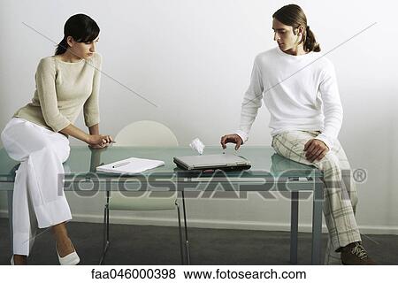Colleagues flicking paper ball back and forth across table View Large Photo Image Stock Photo - Colleagues flicking paper ball back and forth across table. Fotosearch