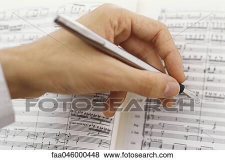 Stock Photo - Composer editing musical score. Fotosearch