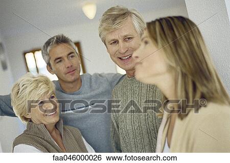 Couple visiting with in-laws View Large Photo Image Stock Photograph - Couple visiting with in-laws. Fotosearch