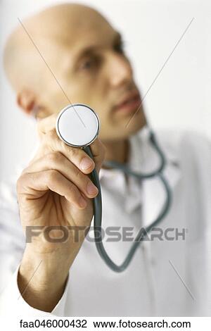 Stock Image - Doctor with stethoscope, personal perspective. Fotosearch