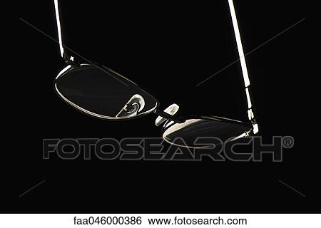 Stock Photograph - Eye glasses on black background. Fotosearch