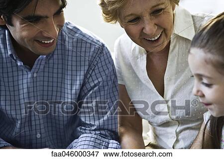 Father, grandmother smiling proudly at little girl View Large Photo Image Stock Photo - Father, grandmother smiling proudly at little girl. Fotosearch