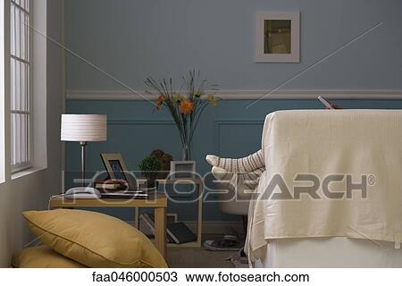 Stock Image - Feet hanging off end of sofa. Fotosearch