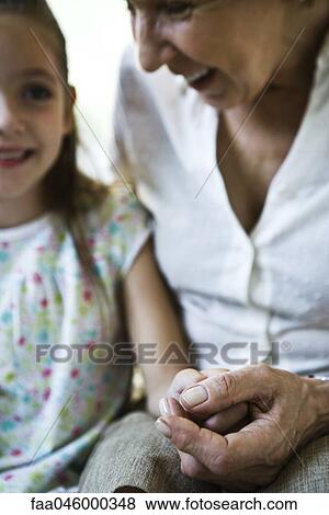 Grandmother and young granddaughter holding hands, close-up View Large Photo Image Stock Photo - Grandmother and young granddaughter holding hands, close-up. Fotosearch