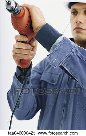 Handyman using drill View Large Photo Image Stock Photography - Handyman using drill. Fotosearch