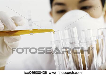 Laboratory technician transferring liquid to test tube View Large Photo Image Stock Photograph - Laboratory technician transferring liquid to test tube. Fotosearch