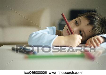 Little boy pausing while drawing, resting head on arm View Large Photo Image Stock Photography - Little boy pausing while drawing, resting head on arm. Fotosearch
