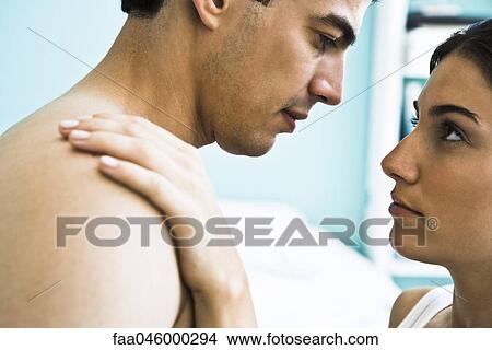 Man and woman embracing, looking into the other's eyes View Large Photo Image Picture - Man and woman embracing, looking into the other's eyes. Fotosearch