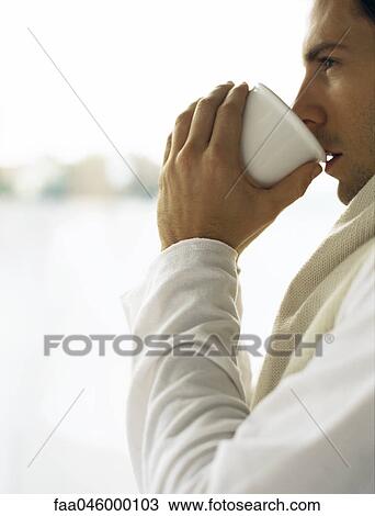Man drinking cup of coffee, looking away View Large Photo Image Stock Image - Man drinking cup of coffee, looking away. Fotosearch