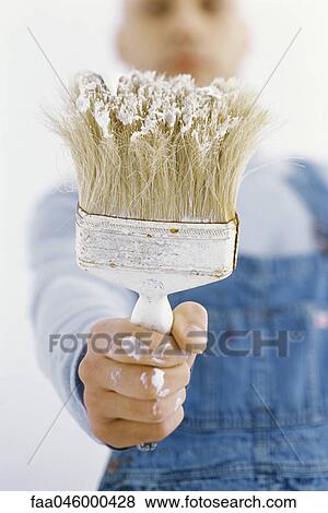 Stock Photo - Man holding out paintbrush. Fotosearch