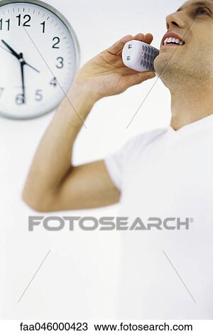 Man on phone call, clock in background View Large Photo Image Stock Image - Man on phone call, clock in background. Fotosearch