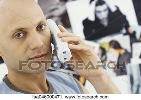 Man on phone call, looking at camera View Large Photo Image Stock Image - Man on phone call, looking at camera. Fotosearch