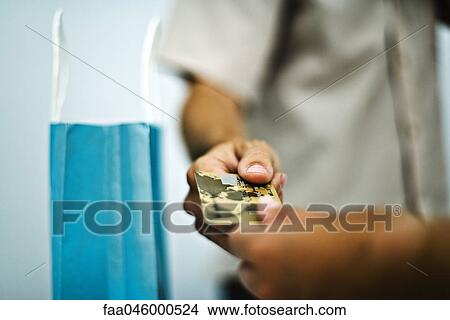 Man paying for purchase with credit card, cropped, close-up View Large Photo Image Picture - Man paying for purchase with credit card, cropped, close-up. Fotosearch