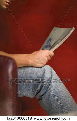 Stock Photo - Man reading magazine. Fotosearch